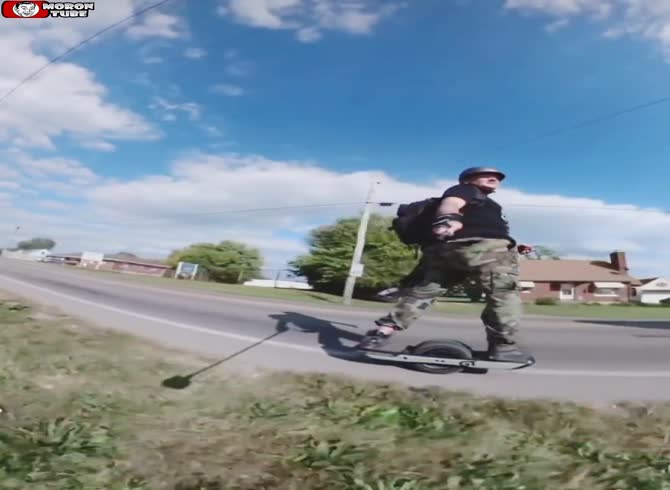 Video :A skateboarder is kicked by a biker to cause him to tumble onto the road